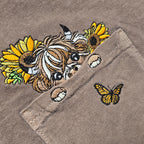 Embroidered design on a fabric with flowers and a butterfly.